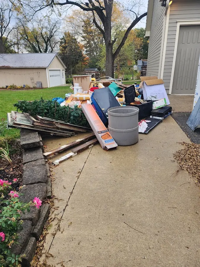 Dumpster being loaded with debris for Estate Cleanout Dumpster Rental in Collierville